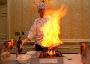 Chef with flaming dish